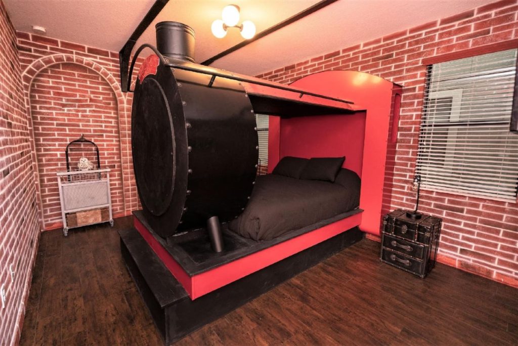 There is a bedroom with red brick walls like Platform 9 and 3/4, complete with a half-vanished truck and Hedwig's cage. The bed is black and red and shaped as the front of the Hogwarts Express.