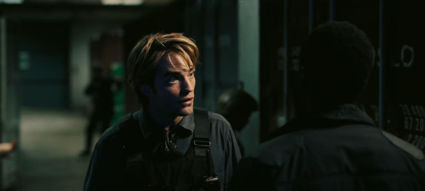 Robert Pattinson is surprised to hear something John David Washington is saying in this film still from “Tenet”.