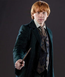 Ron wearing a suit and holding a wand