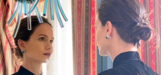 Katherine Waterston faces her reflection in a mirror.
