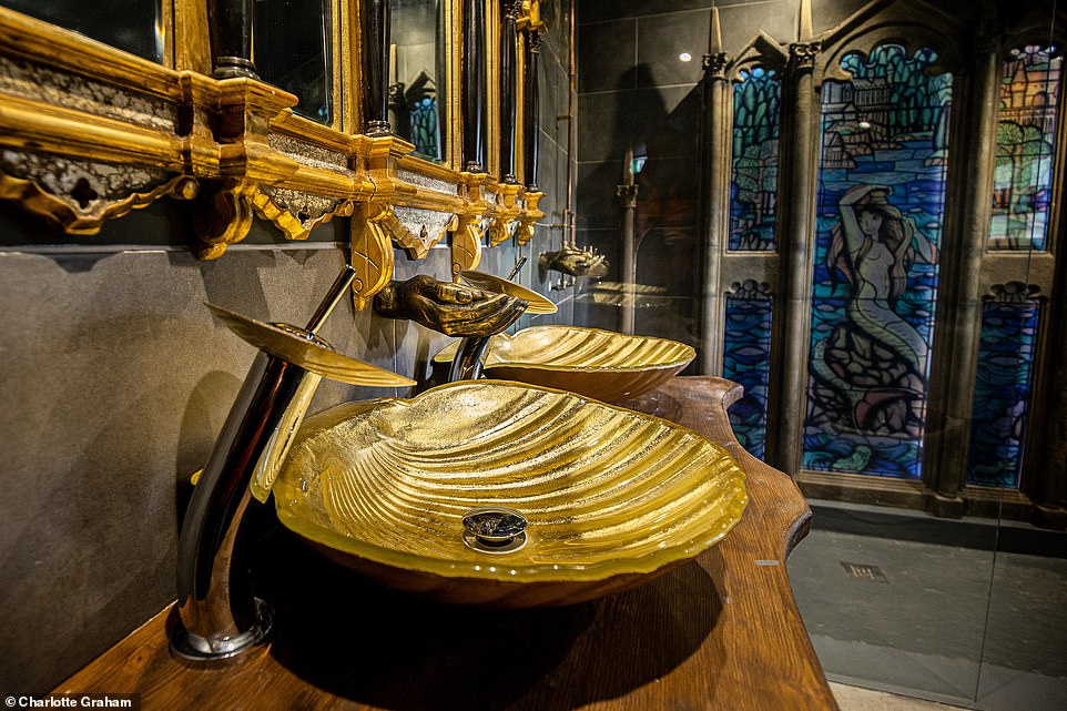 The Dorm accommodation has luxurious gold shell basins in the bathroom and a gothic style gilded mirror.