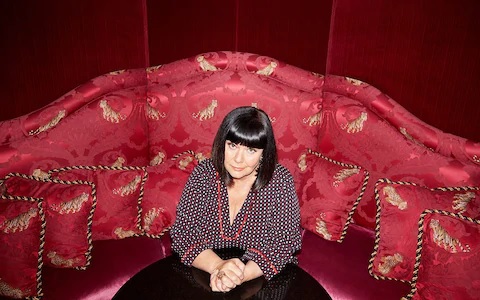 Dawn French is pictured, seated on a red coach, during an interview with the "Telegraph".