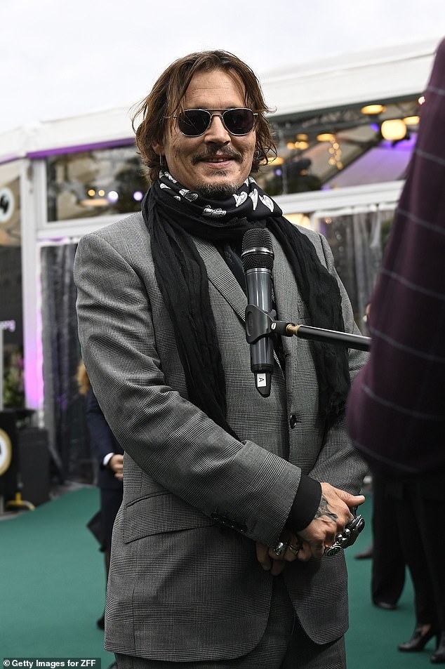 Johnny Depp smiles during an interview at the Zurich Film Festival.