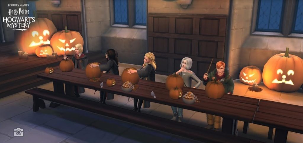 Characters from "Hogwarts Mystery" carve pumpkins in the Great Hall.