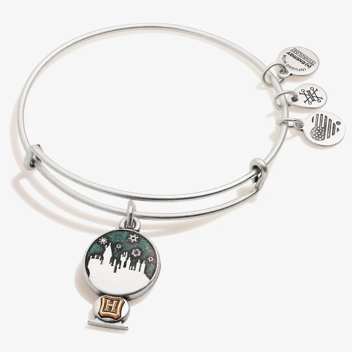 Pictured is a snowy Hogwarts inside a snow globe on a bangle bracelet from Alex and Ani.