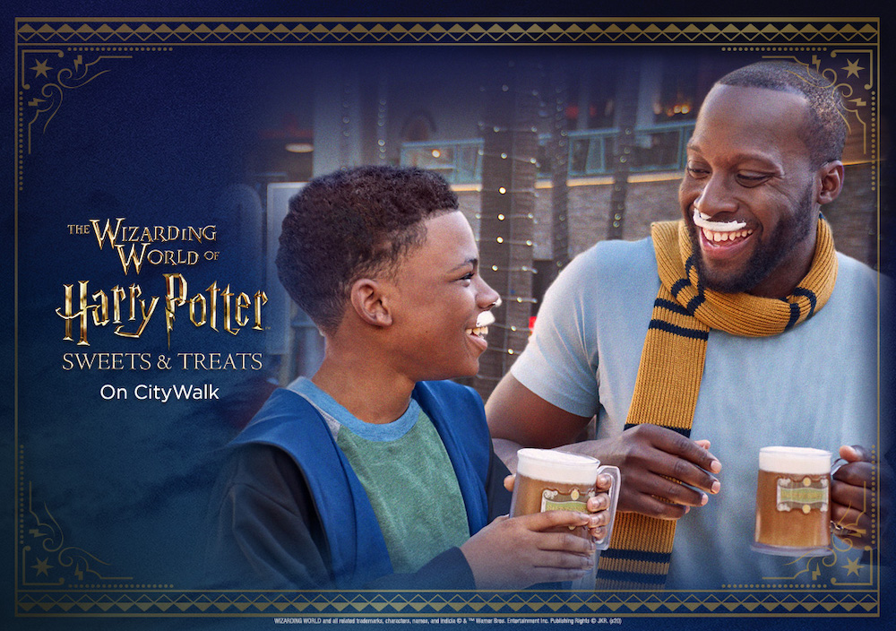 A young boy in wizards' robes laughs with a man wearing a Hufflepuff scarf, both are holding cups of Butterbeer and have Butterbeer foam moustaches. Text on the left of the photo reads "The Wizarding World of Harry Potter Sweets and Treats on City Walk."