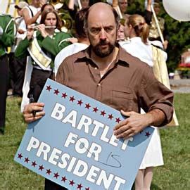 Toby Zeigler holding a sign