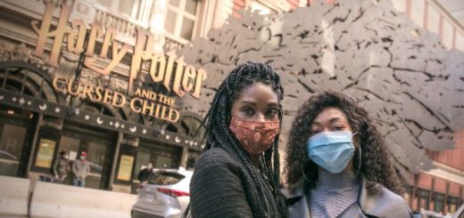 Jenny Jules and Nadia Brown pose in face masks outside the Lyric Theare on Broadway where Harry Potter and the Cursed Child is written over the entrance.