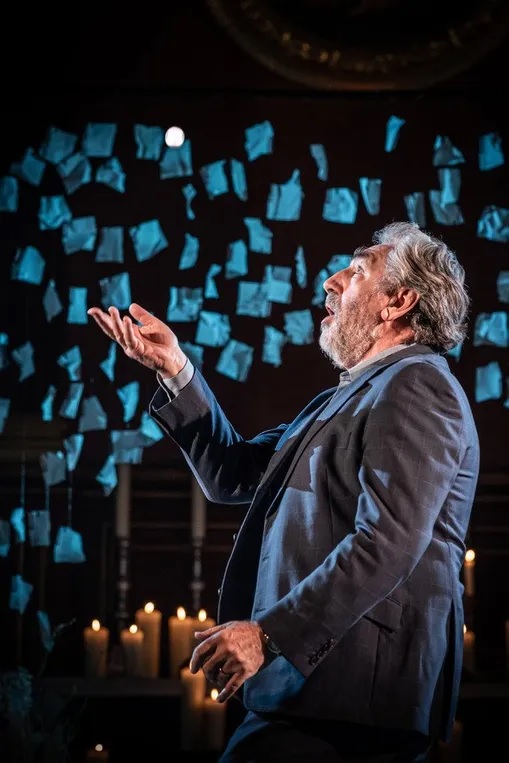 Jim Carter orates, hand outstretched, in a still image from the Donmar Warehouse’s holiday production.