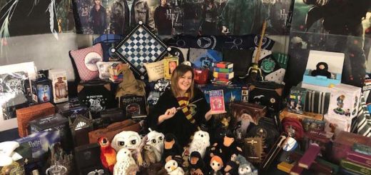 Victoria Maclean sits on the floor surrounded by her Wizarding World merchandise collection.