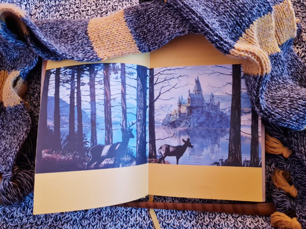 "Harry Potter" film concept art of the view of Hogwarts across the Black Lake with trees and deer featured in "Loyalty: A Guided Journal for Embracing Your Inner Hufflepuff" from Insight Editions