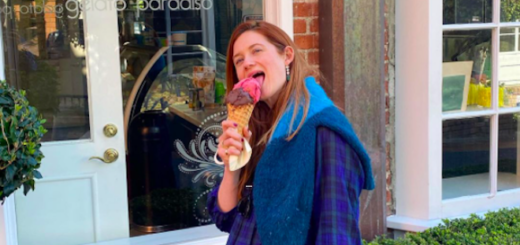 Bonnie Wright eats an ice cream cone while standing outside of an ice cream and gelato shop.