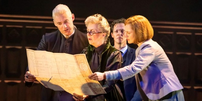 Cursed Child actors of Draco Malfoy, Minerva Mconagall, Harry Potter and Ginny Weasley are in character and on stage looking at the Marauders Map.