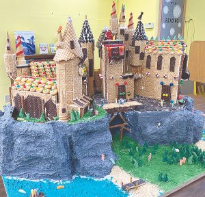 Father and son construct graham cracker castle for New Baden, Illinois, library display