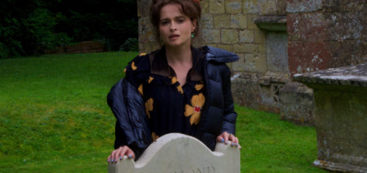 Helena Bonham Carter standing behind headstone