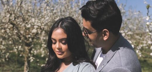 Afshan Azad poses with her husband in front of an orchard.