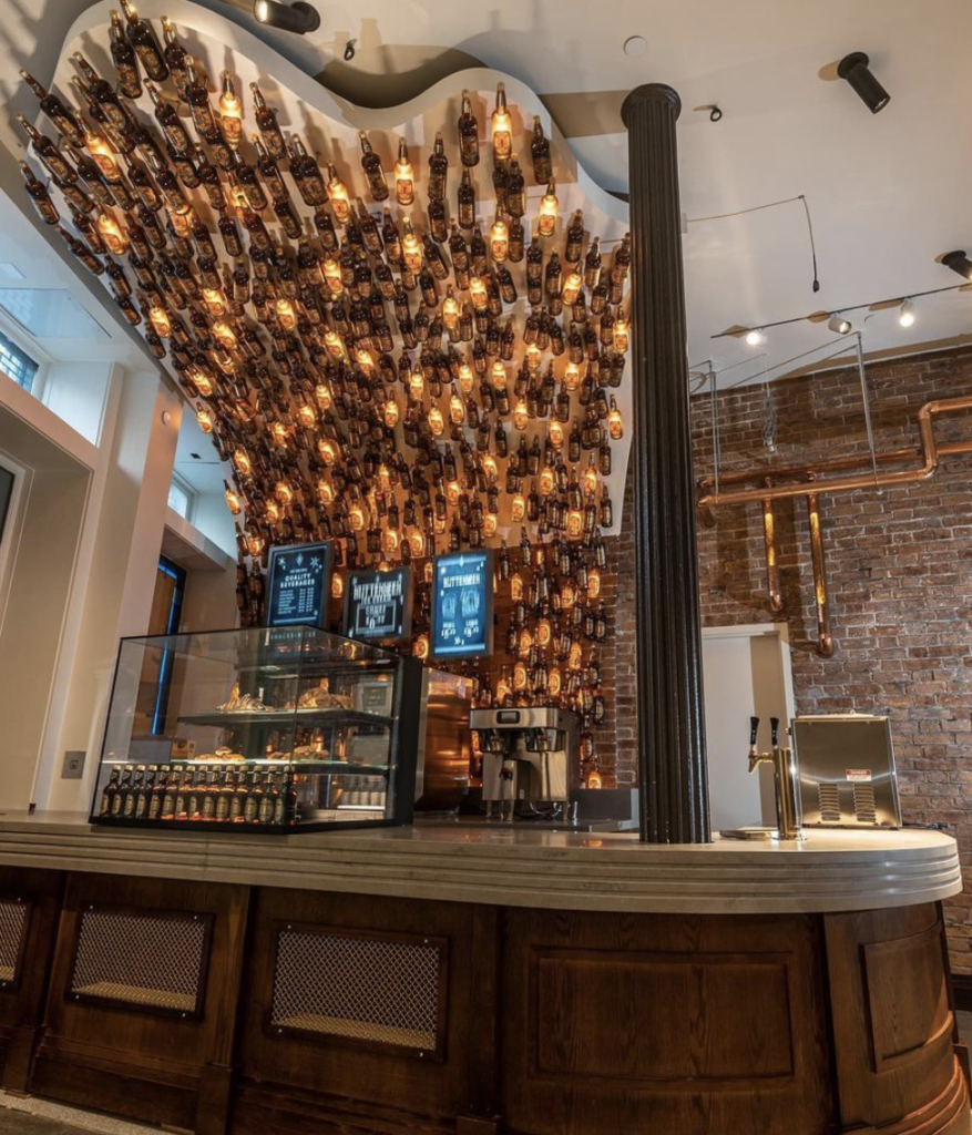 Butterbeer bottles are attached to the ceiling with lights coming from the insides.