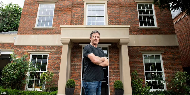 Jason Isaacs stood in front of the mansion that is up for raffle for Great Ormond Street Hospital
