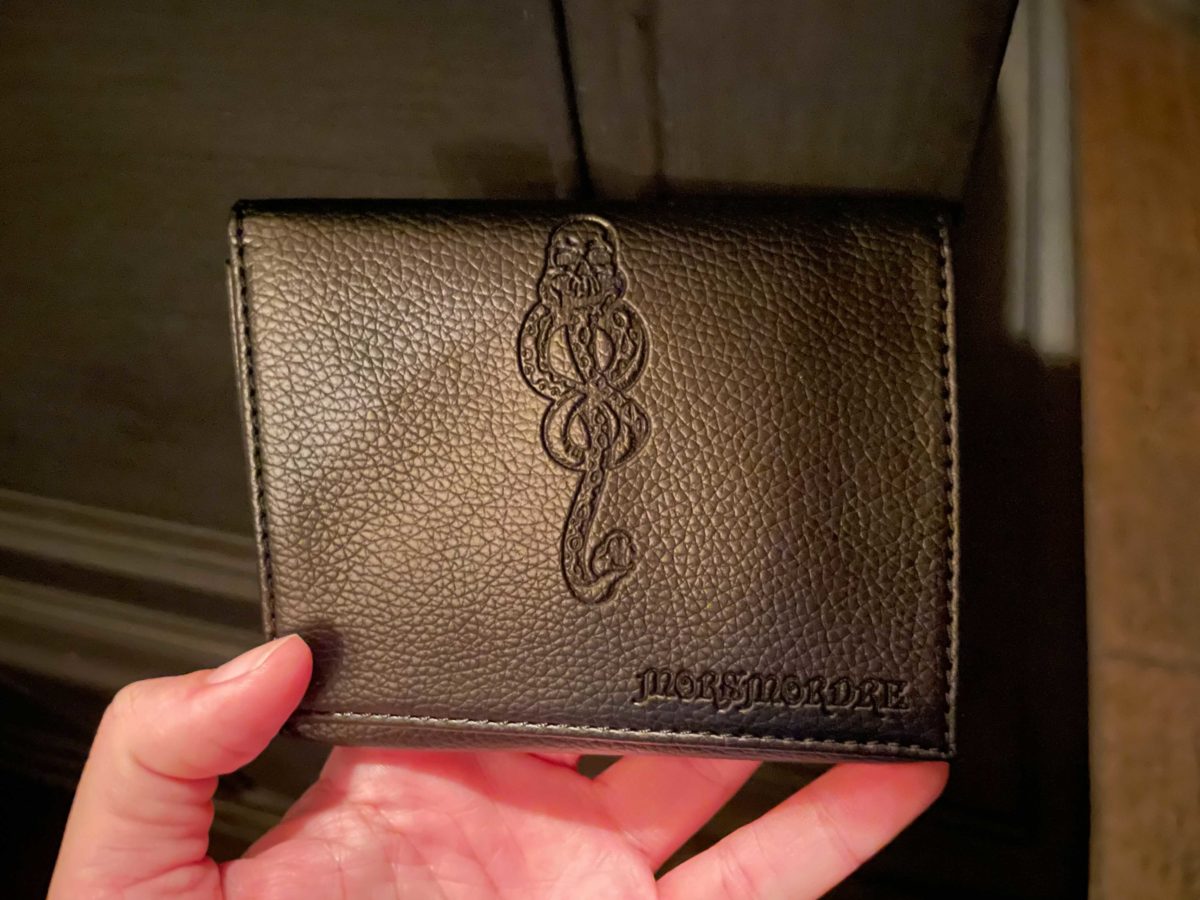 Both the Dark Mark and its incantation are embossed on the wallet.