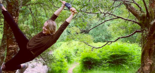 Evanna Lynch swings on a rope swing hanging from a tree.