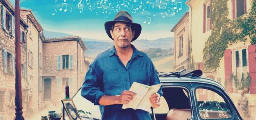 Ciaran Hinds as the Man in the Hat with a car and a French small town bacdrop on the movie poster for The Man in the Hat.