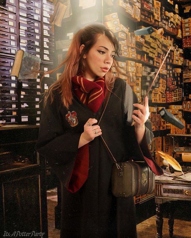 A photographer's self-portrait depicts a floating wand and her Hogwarts House robes