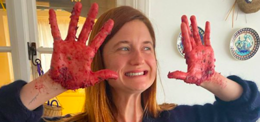 Bonnie Wright holds up her hands and smiles, her hands are messy from making veggie burgers.