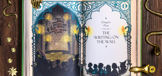 A copy of MinaLima' "Harry Potter and the Chamber of Secrets" is opened on a page showing a chapter title.