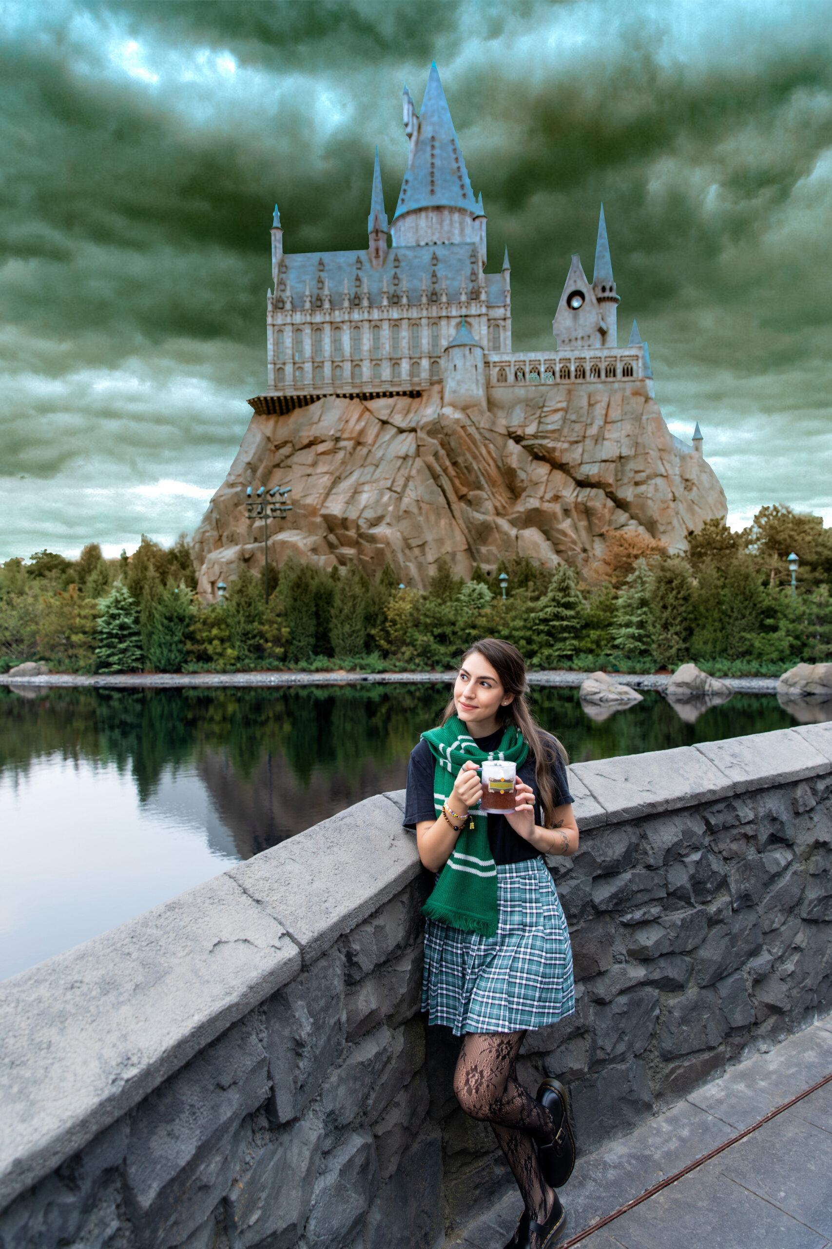 Andrea posing in front of Hogwarts with butterbeer
