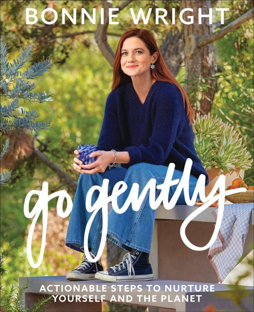 Bonnie Wright revealed two covers for "Go Gently: Actionable Steps to Nurture Yourself and the Planet." The North American cover features Bonnie in front of lush green foliage.
