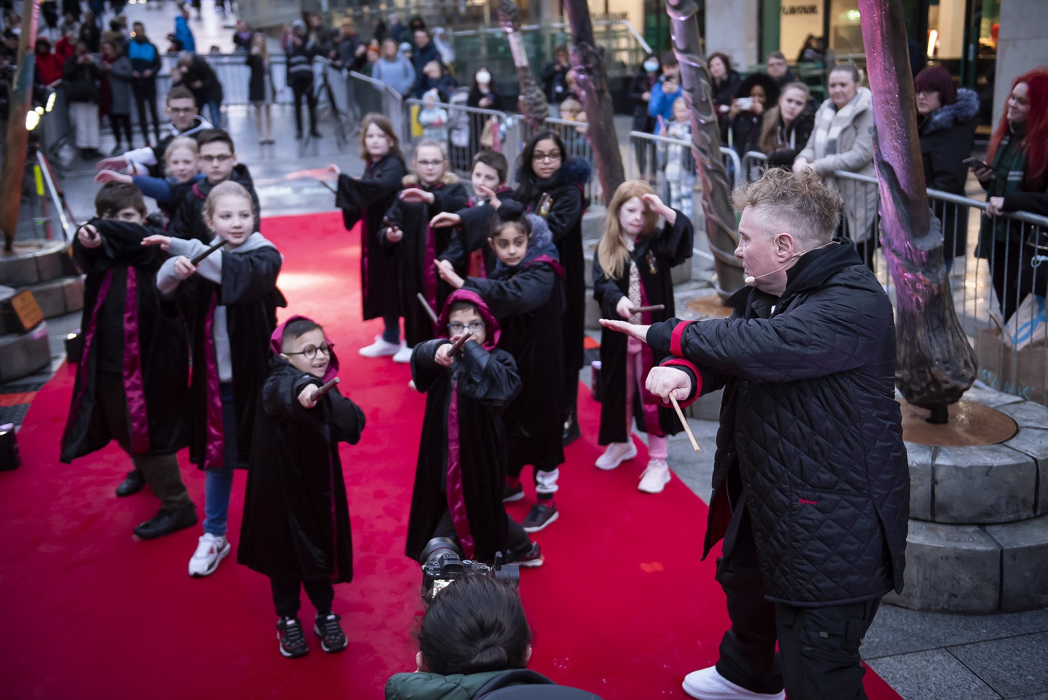Paul Harris teaches wand combat choreography to young fans at the Wizarding World wand installation at the Bullring in Birmingham on March 11, 2022.
