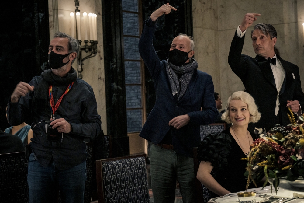 Director David Yates and other crew members are shown on the set of “Fantastic Beasts: The Secrets of Dumbledore,” with actors Alison Sudol (Queenie Goldstein) and Mads Mikkelsen (Gellert Grindelwald) in character.