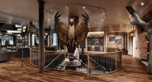 The Atrium of Awe at Harry Potter New York features a Griffin guarding a spiral staircase.