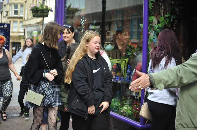 Customers are shown lining up at Whimsic Alley’s grand opening in Falkirk, Scotland.