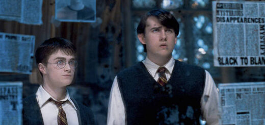 Neville and Harry look in the mirror in the Room of Requirement.