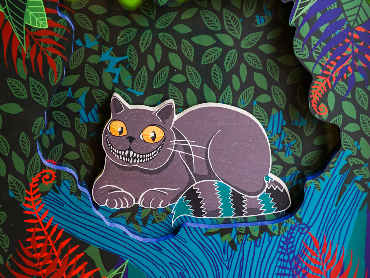 “Enchanted Journeys” features a cat from “Alice’s Adventures in Wonderland.” (Source: MinaLima)
