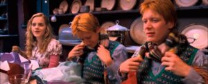 Hermione Granger, Fred and George Weasley opening their Christmas gifts.