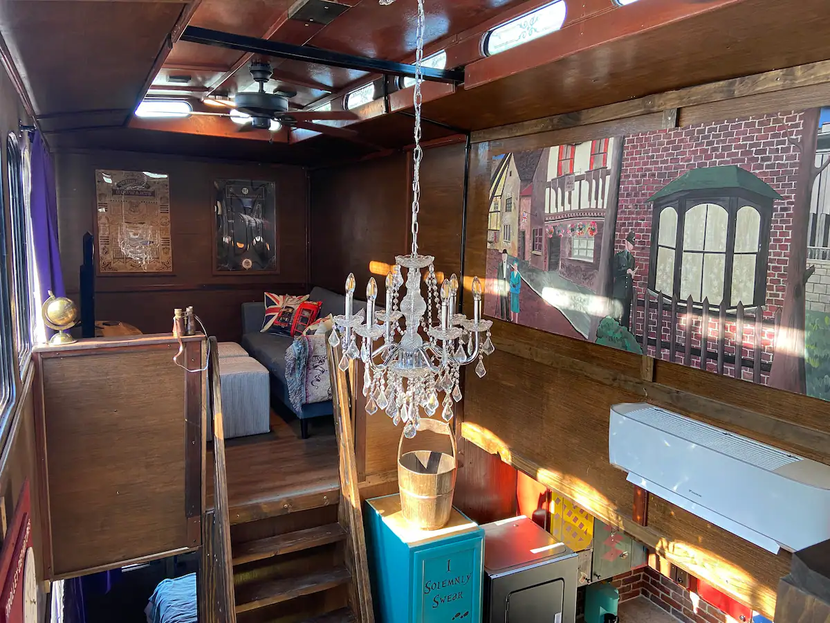The upper space of the Wizard’s Trolley interior includes a gorgeous chandelier and mural for guests to enjoy.