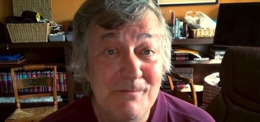 Stephen Fry sitting in home office