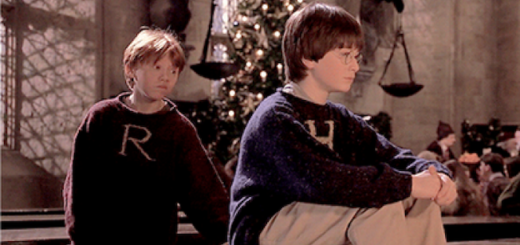 Ron and Harry are wearing Christmas sweaters.