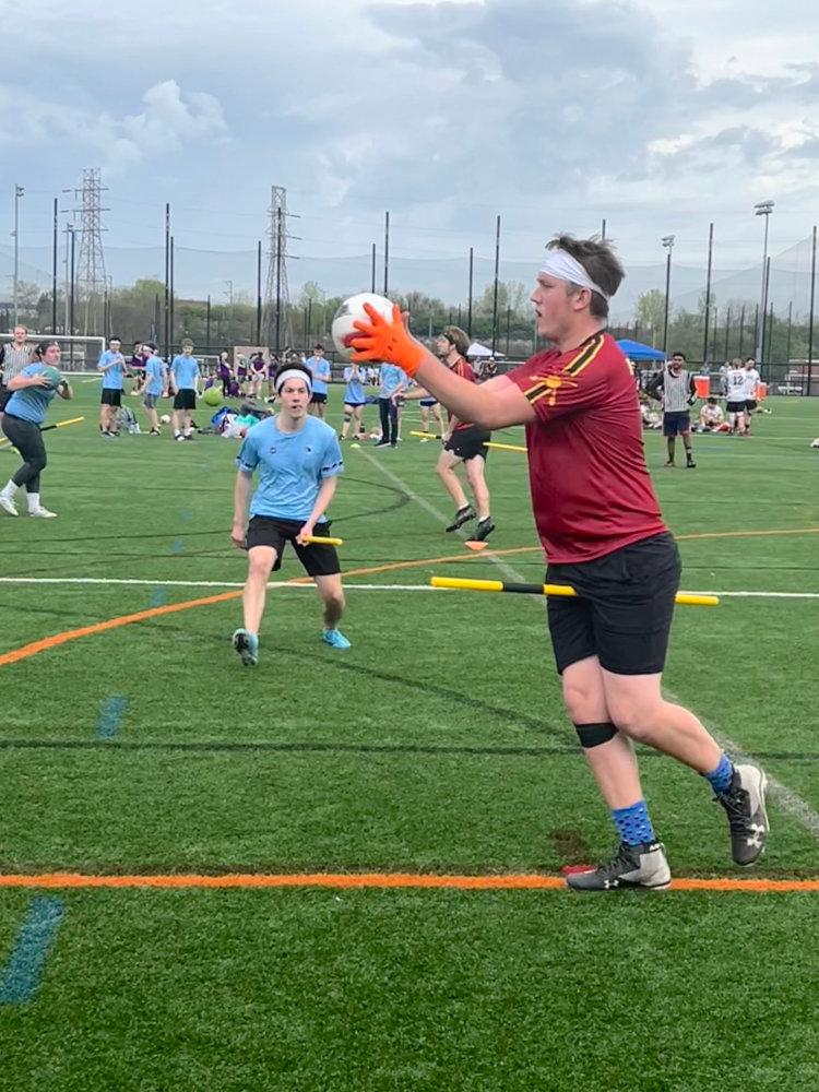 Quadball players are shown in play during the match between Tufts University and Minnesota.