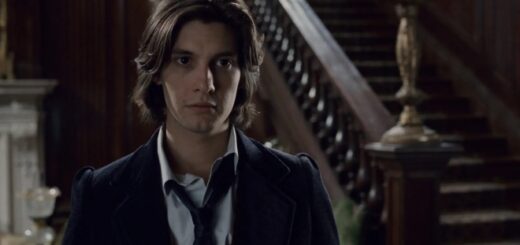 The picture shows Ben Barnes in the film The Portrait of Dorian Gray. He stands next to an ornate, dark wood staircase, and is wearing a shirt, blazer, and loose tie. In this picture, he looks like a young Sirius Black