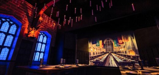 Great Hall display at Harry Potter: The Exhibtion with dining tables and floating candles