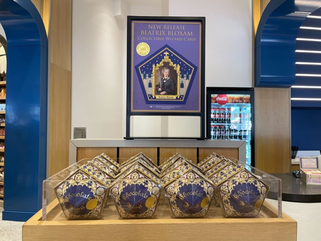 New Chocolate Frog boxes are displayed in front of a sign announcing the new Wizard Card.