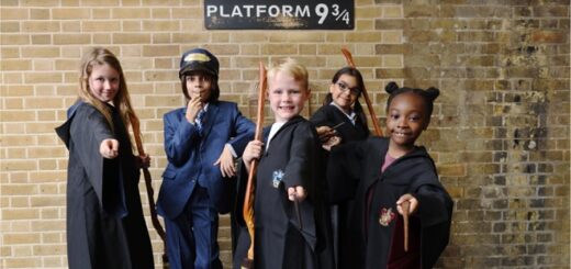 Five kids in front of Platform 9 3/4 sign at King's Cross