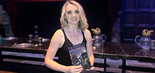 Evanna Lynch holding Jonny Duddle-illustrated copy of "Harry Potter and the Philosopher's Stone"
