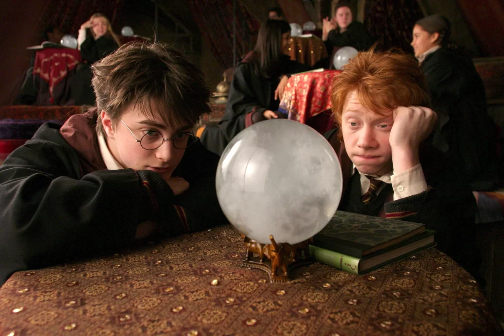A still from Harry Potter and the Prisoner of the Azkaban showing Harry and Ron in their Divination class