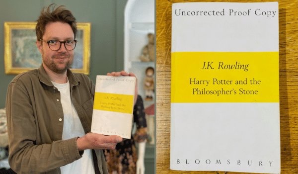 Jim Spencer from Hansons Auctioneers holds a proof copy of "Harry Potter and the Philosopher’s Stone" (Credit: Hansons Auctioneers)