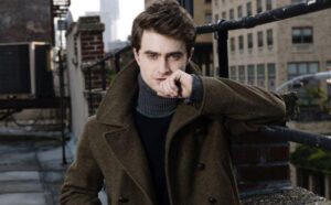 Daniel Radcliffe wearing a peacoat with a popped collar with a turtleneck inside, styled for "JFK" magazine