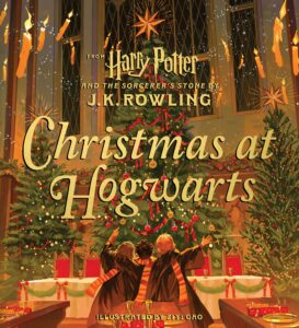 The cover of "Christmas at Hogwarts" depicts the decorated Great Hall in all its yuletide glory with three Christmas trees and a banquet table.